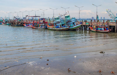 View of fishing boats moored at harbor