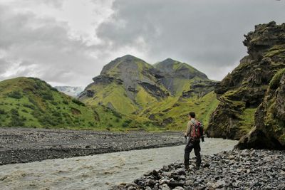 Rear view of man standing on mountain