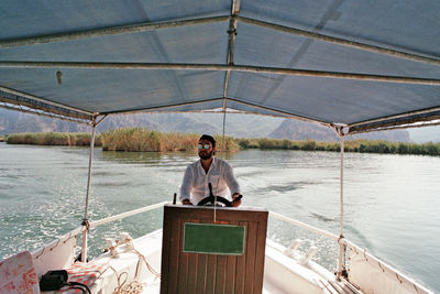 Man sitting on boat in sea