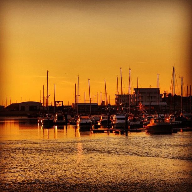 sunset, transportation, nautical vessel, mode of transport, boat, moored, water, orange color, mast, sea, sailboat, reflection, harbor, waterfront, sky, beauty in nature, travel, tranquil scene, clear sky, tranquility