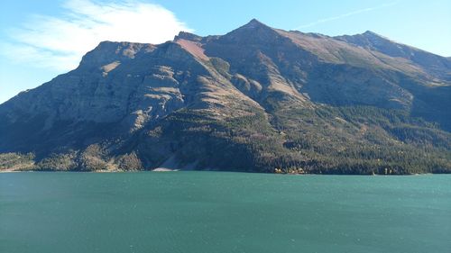 Calm lake against rocky mountains