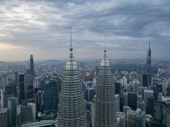 Cityscape against cloudy sky