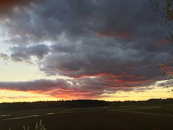 Scenic view of dramatic sky over landscape during sunset