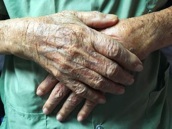 Midsection of couple holding hands