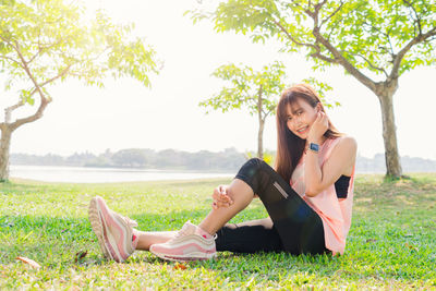 Full length of woman sitting on grass