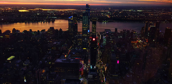 High angle view of illuminated buildings against sky at night