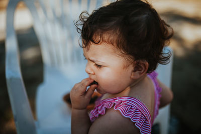 Close-up of baby girl eating blackberry