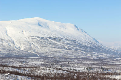 Scenic view of snowcapped mountains against clear sky