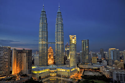 Malaysia, kuala lumpur, petronas towers and surrounding downtown skyscrapers at dusk