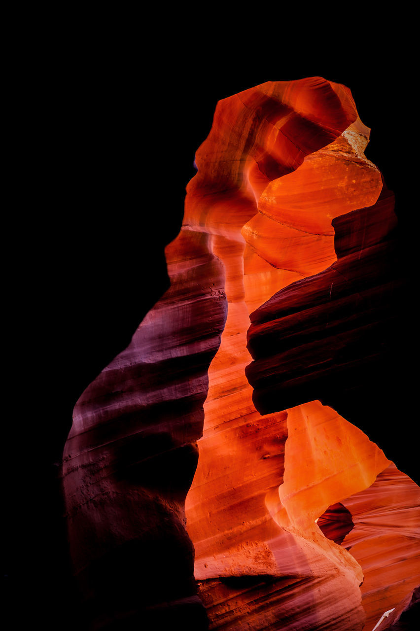 rock, rock formation, geology, no people, nature, beauty in nature, sandstone, eroded, physical geography, non-urban scene, darkness, travel destinations, orange color, black background, red, outdoors, canyon, tranquility, travel