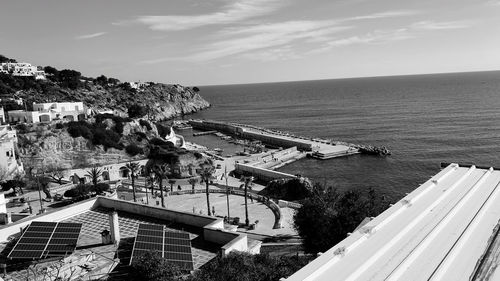 High angle view of townscape by sea against sky