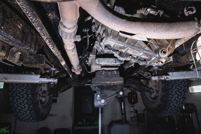 View of the off-road car from below on the lift. auto service center. vehicle maintenance