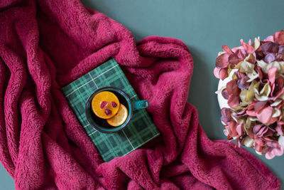Hot tea and a book on a cozy fuzzy blanket