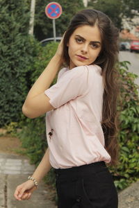 Portrait of beautiful young woman standing outdoors