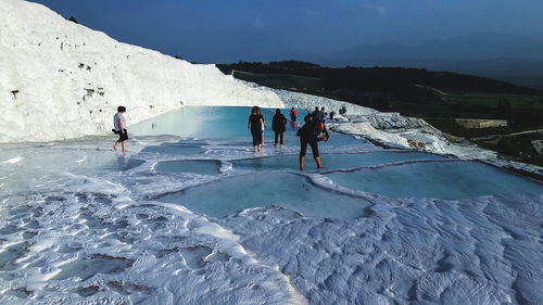 People at lake during winter