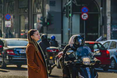 Woman standing on city street