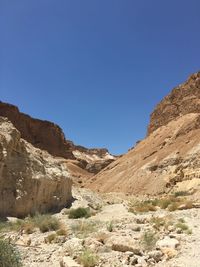 Scenic view of mountains against blue sky