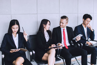 Young women sitting on laptop in office