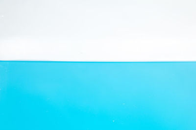 Full frame shot of blue water against white background