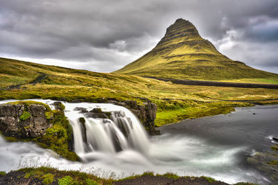 Scenic view of waterfall against sky