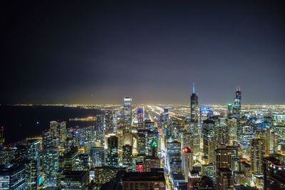 High angle view of city lit up at night