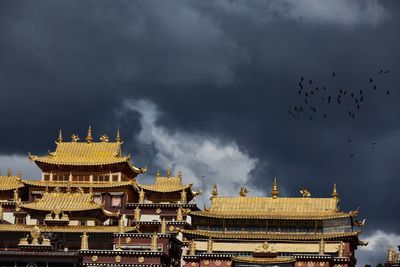 High section of built structure against clouds