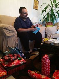 Man sitting on sofa at home