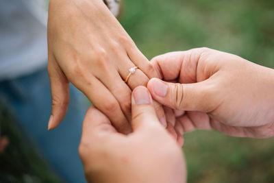 Midsection of couple holding hands