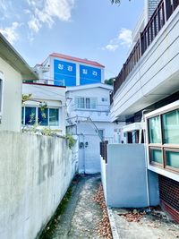Road amidst buildings against sky