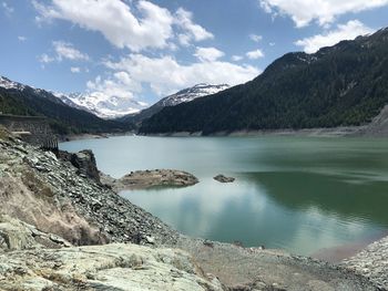 Scenic view of lake and mountains against sky