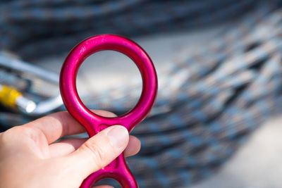 Close-up of woman hand holding pink umbrella