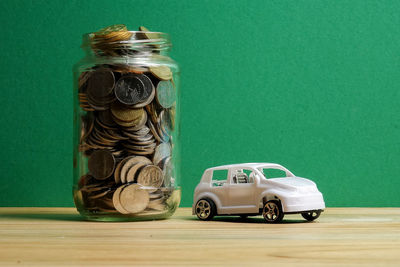 Toy car on table against wall