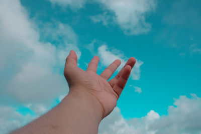 Close-up of hand holding blue sky