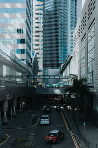 Cars on city street amidst buildings