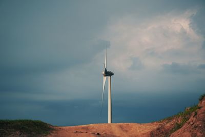 Low angle view of windmill against sky