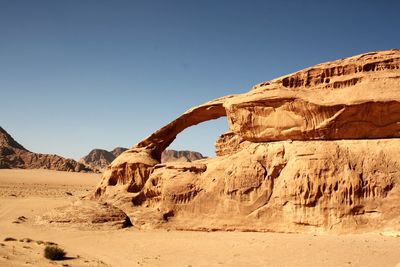 Rock formations in desert against clear sky