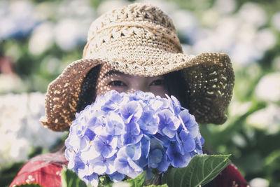 Portrait of woman holding purple flowers