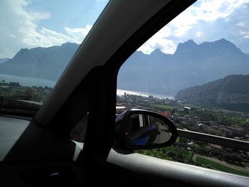 Reflection of mountains in side-view mirror