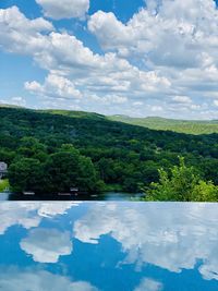 Scenic view of swimming pool by lake against sky