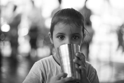 Close-up portrait of girl drinking from glass