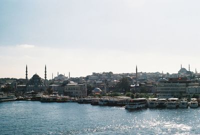 City at waterfront against sky