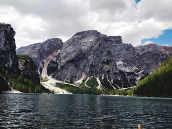 Scenic view of lake by mountains against sky