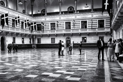 People walking in corridor of building