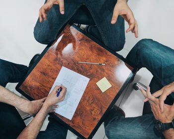 High angle view of business colleagues having meeting in office