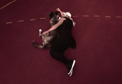 High angle view of young woman jumping outdoors