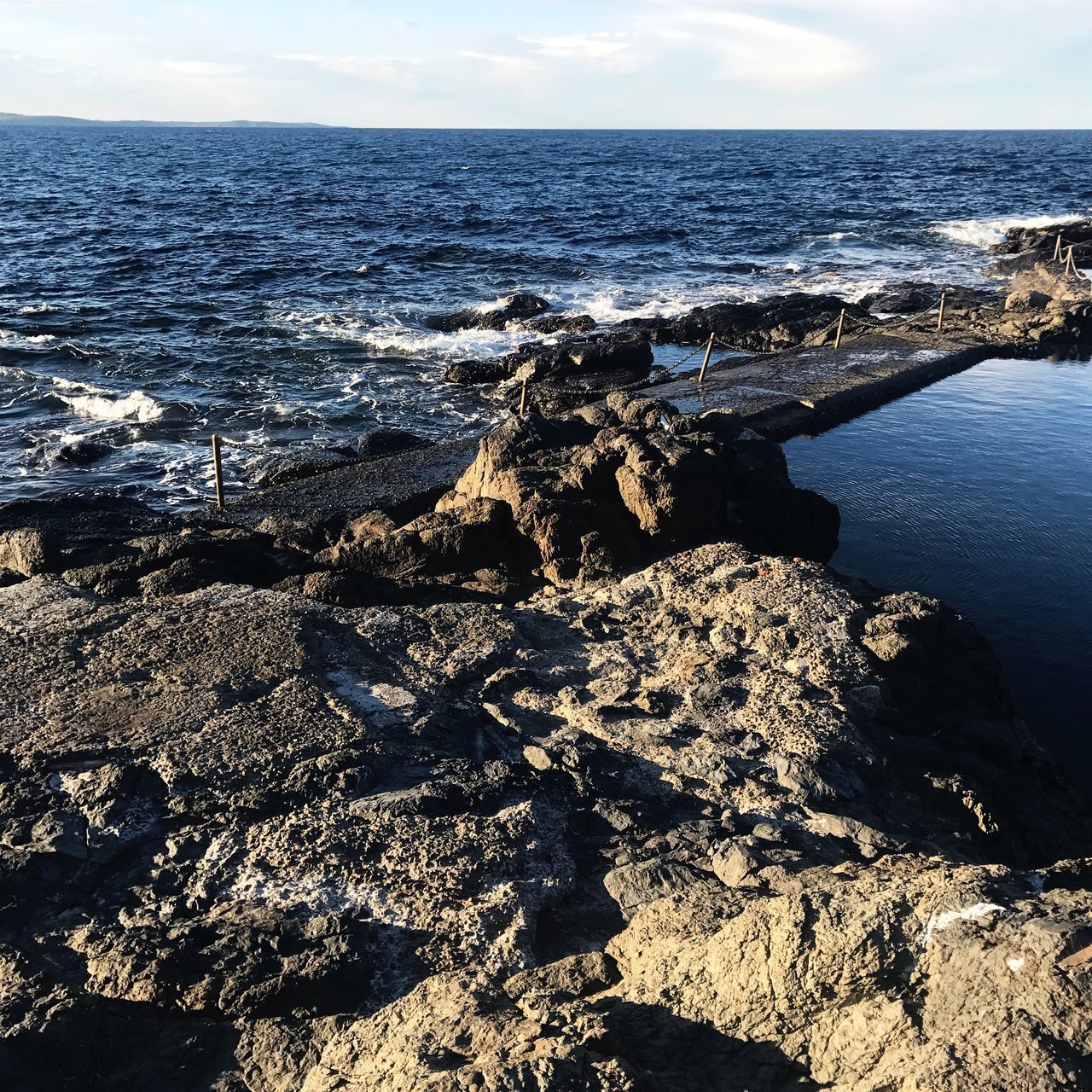 sea, nature, beauty in nature, water, horizon over water, scenics, tranquil scene, tranquility, rock - object, no people, outdoors, sky, beach, sunlight, day, wave