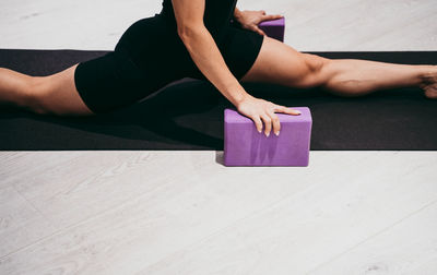 Midsection of woman stretching at gym