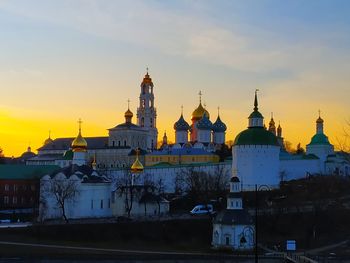 Buildings against sky during sunset in city