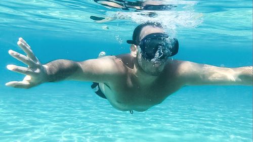 Woman jumping in swimming pool