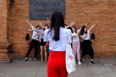 People standing against wall